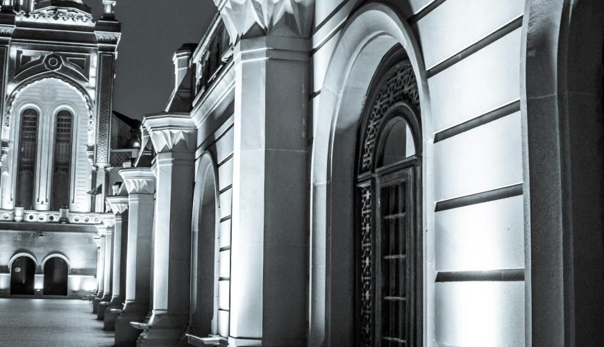 A black and white photo of a building at night