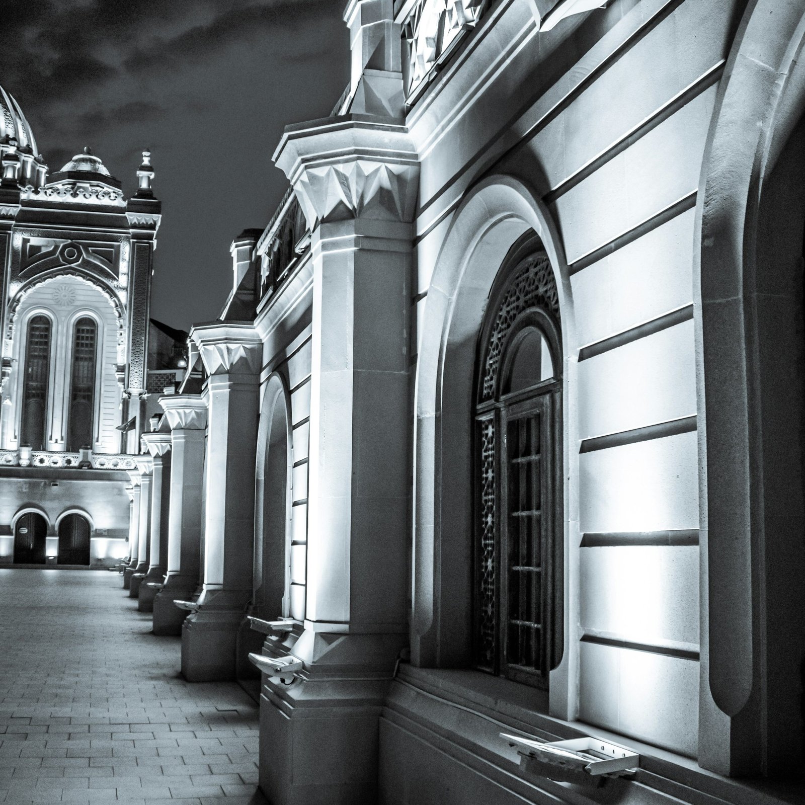 A black and white photo of a building at night