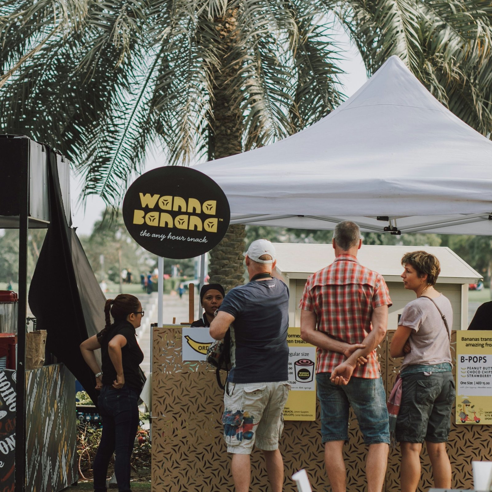 a group of people standing under a tent