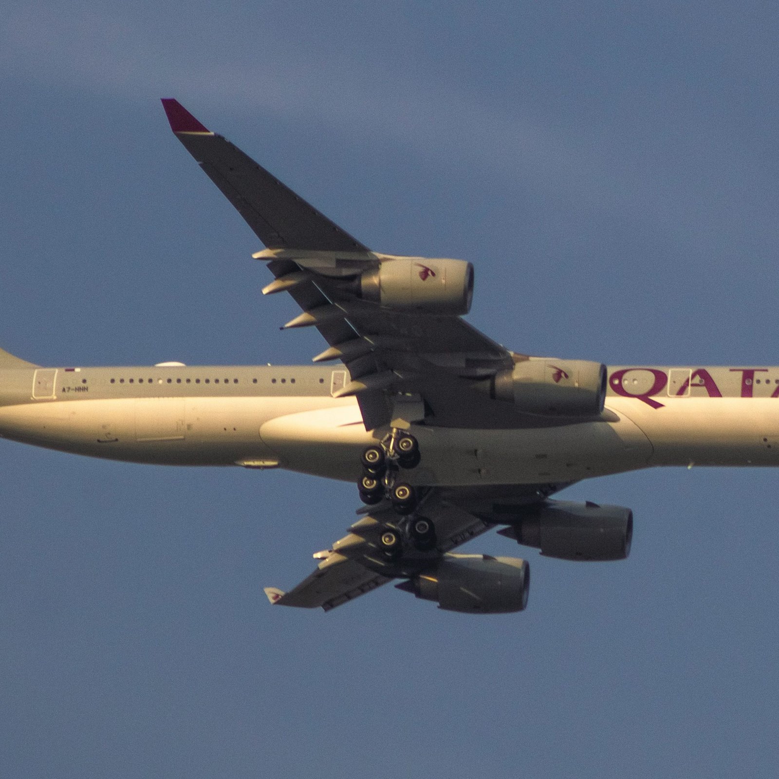 a large jetliner flying through a blue sky