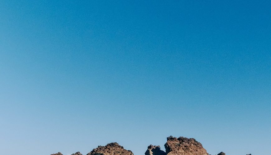 a large rock formation in the middle of a desert