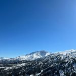 a view of a snowy mountain range from a ski lift