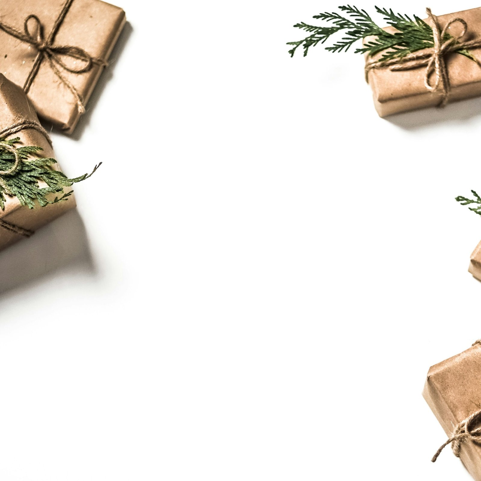 four brown gift boxes on white surface